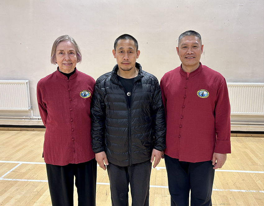 Master Chen Ziqiang with Shifu Liu and colleague posing together in a hall
